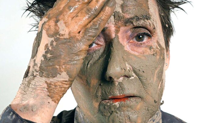 a face covered with clay