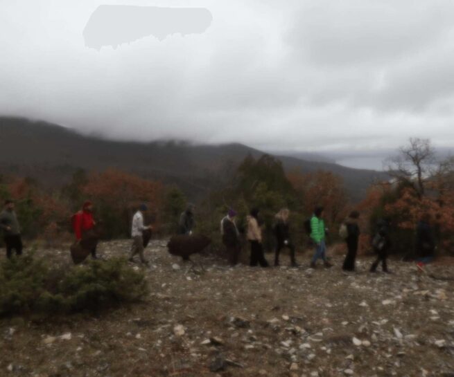 people walking on the mountain on a cloudy and rainy day