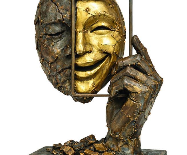 bronze sculpture of a face and a hand