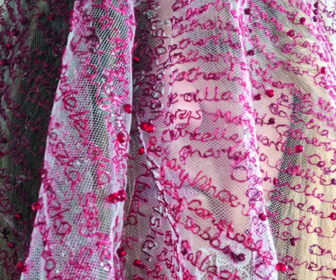 White textile with words in pink