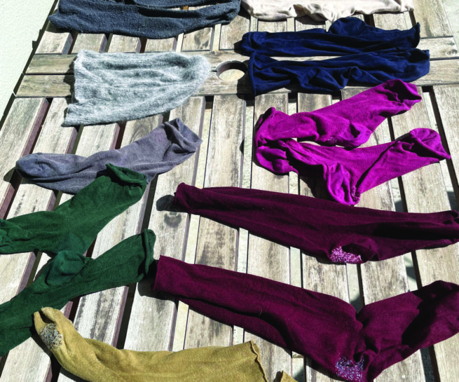 Socks in different colours on a wooden surface