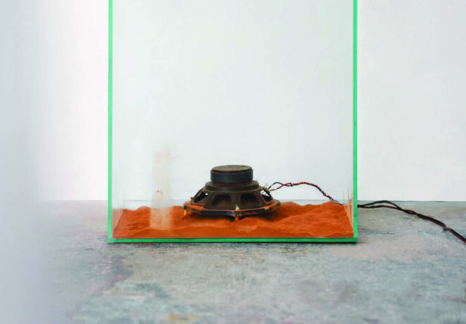 a speaker inside a glass showcase