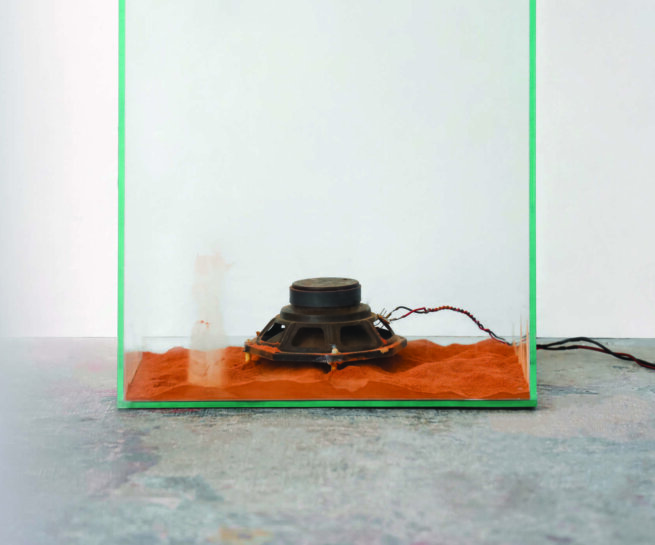 a speaker inside a glass showcase