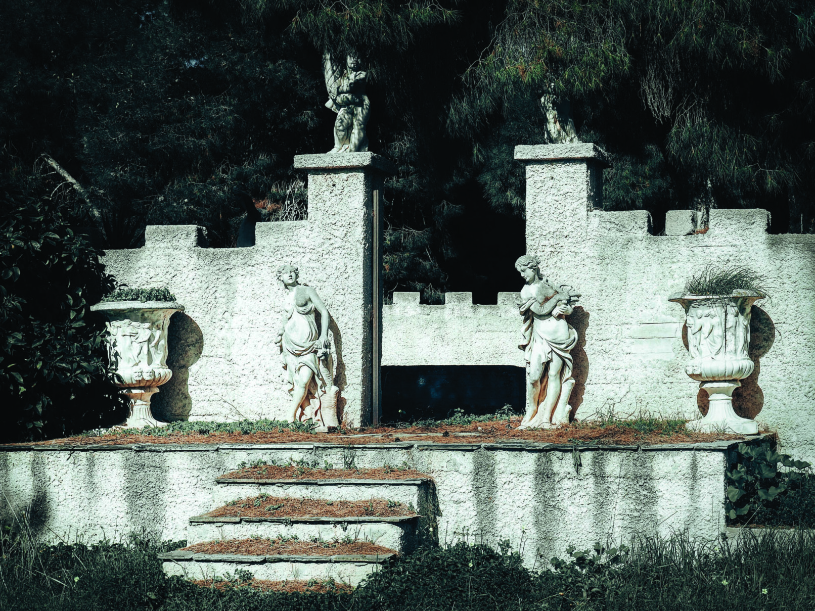 two sculptures in front of an entrance