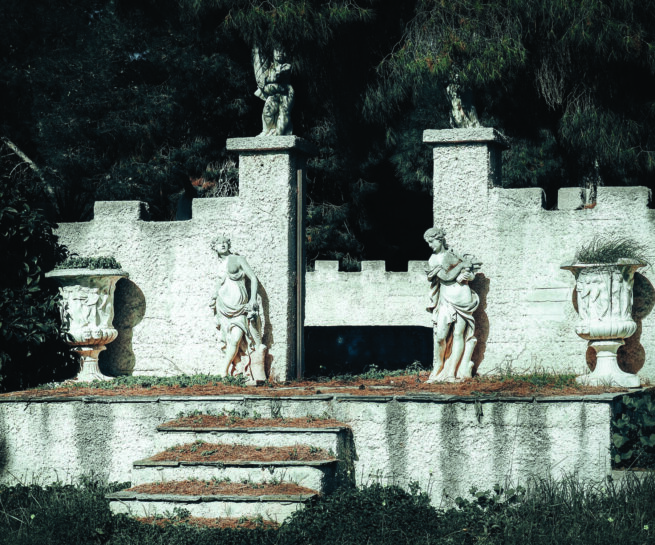 two sculptures in front of an entrance