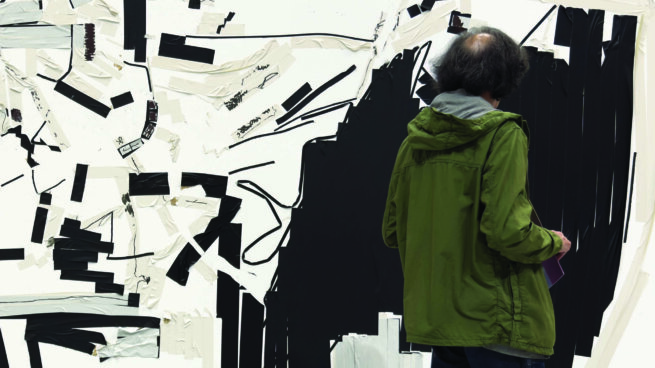 a person looking at an artwork