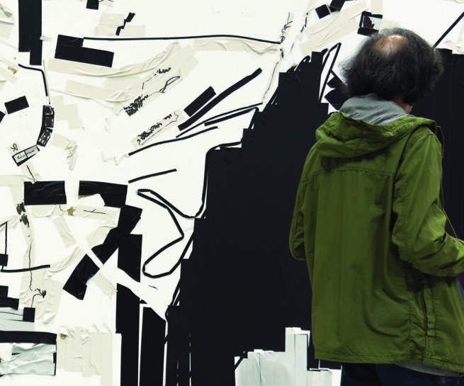 a person looking at an artwork
