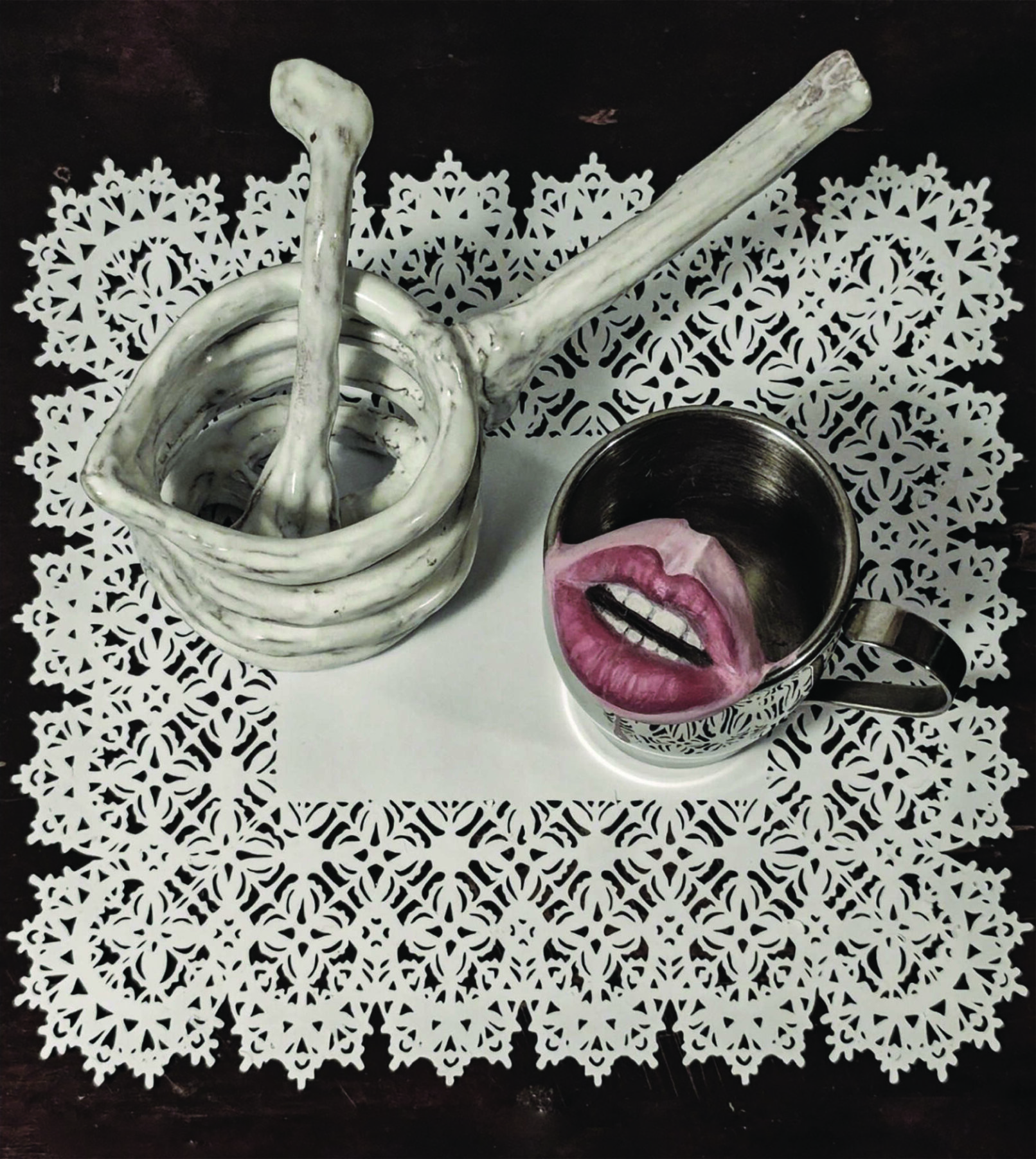 Still life showing a cup with a mouth inside