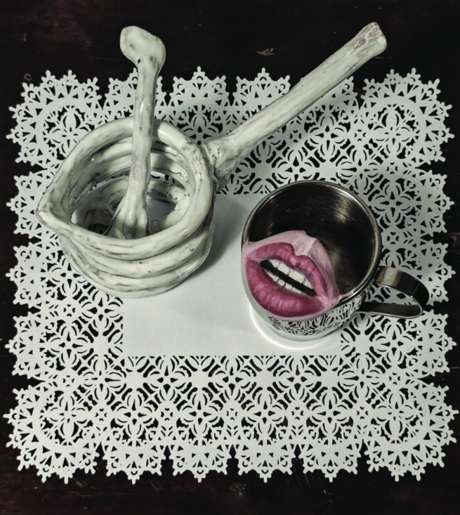 Still life showing a cup with a mouth inside