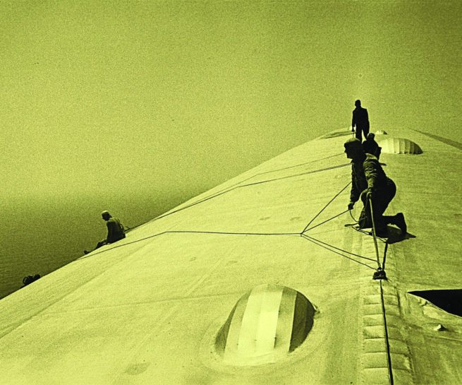 Four people on top of a building